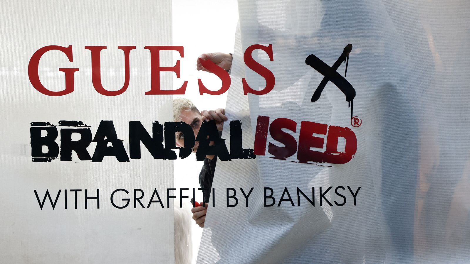 Banksy urges shoplifters to 'help themselves' to Guess clothing after copyright row