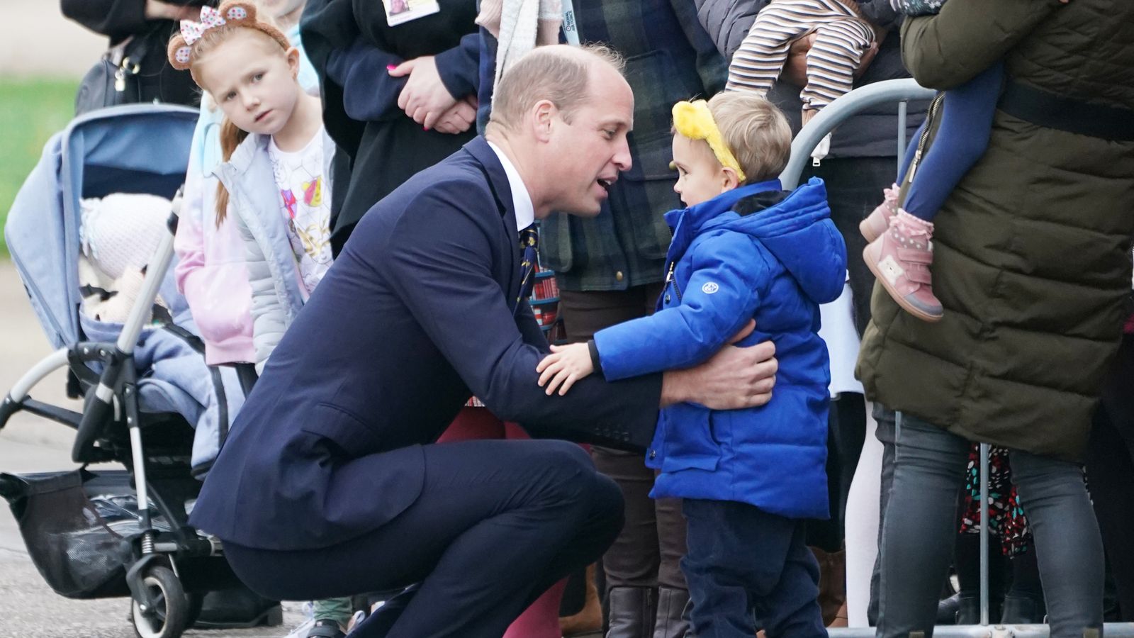 Prince of Wales promises to put a little boy's drawing 'on the royal fridge' during visit to RAF base