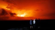 People watch the eruption of Mauna Loa, Monday, Nov. 28, 2022, near Hilo, Hawaii. Mauna Loa, the world&#39;s largest active volcano erupted Monday for the first time in 38 years. (AP Photo/Marco Garcia)