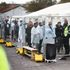 People stand inside a fenced off area inside the migrant processing centre in Manston, Britain, November 7, 2022. REUTERS/Henry Nicholls