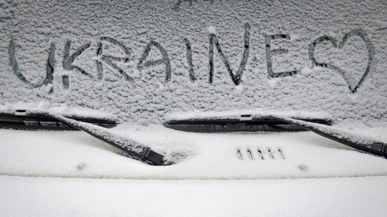 A heart is designed next to the word ''Ukraine'' on the window of a car covered by light snow in downtown Kyiv, Ukraine, Thursday, Nov. 17, 2022. (AP Photo/Andrew Kravchenko)