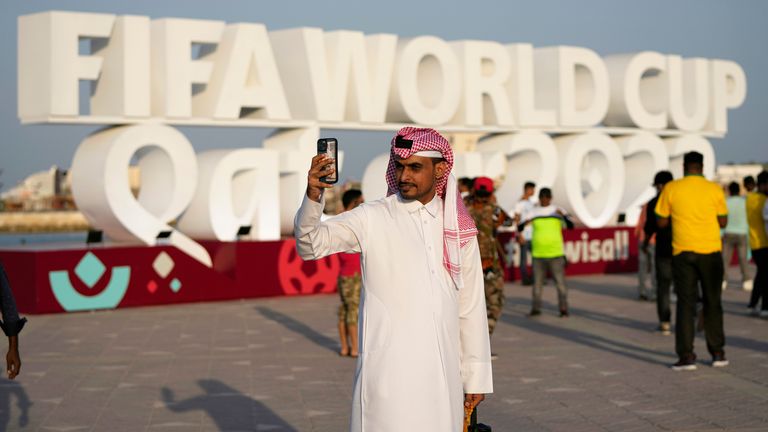 A man takes a selfie with a photograph with a sign reading in English&#34; Fifa World Cup, Qatar 2022&#34; at the corniche in Doha, Qatar
PIC:AP