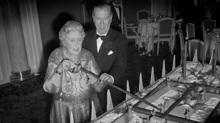 Agatha Christie, author of the record-breaking play 'The Mousetrap', uses a sword to cut a birthday cake, weighing half a ton, at a party at the Savoy Hotel to celebrate the 10th anniversary of the run of her play 'The Mousetrap' at the Ambassador's Theatre. Helping her is Peter Saunders, who presents the play. Pic: PA