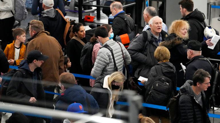 Travelers wait to go through security check point at O&#39;Hare International Airport in Chicago, Wednesday, Nov. 23, 2022. (AP Photo/Nam Y. Huh)