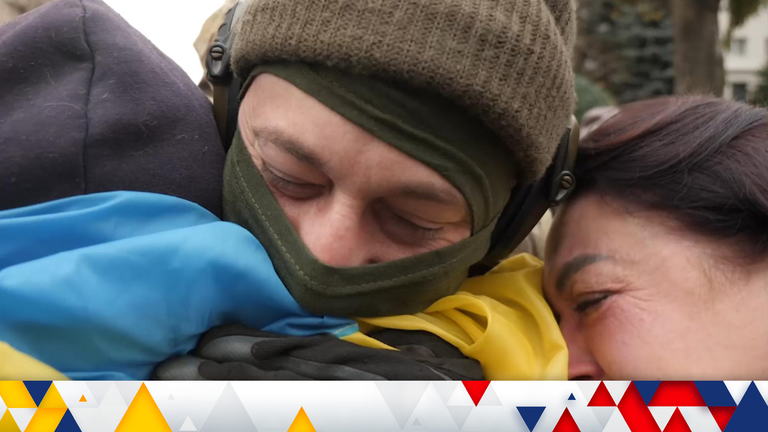 A Ukrainian soldier hugs residents after retaking Kherson