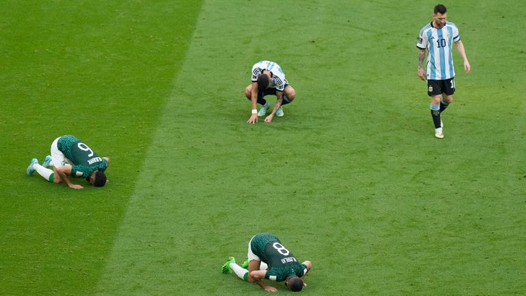 Argentina&#39;s Lionel Messi leaves the pitch as the final whistle goes, as Saudi Arabia players celebrate