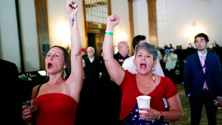 Republican candidate supporters cheer on the latest voting results for Kari Lake