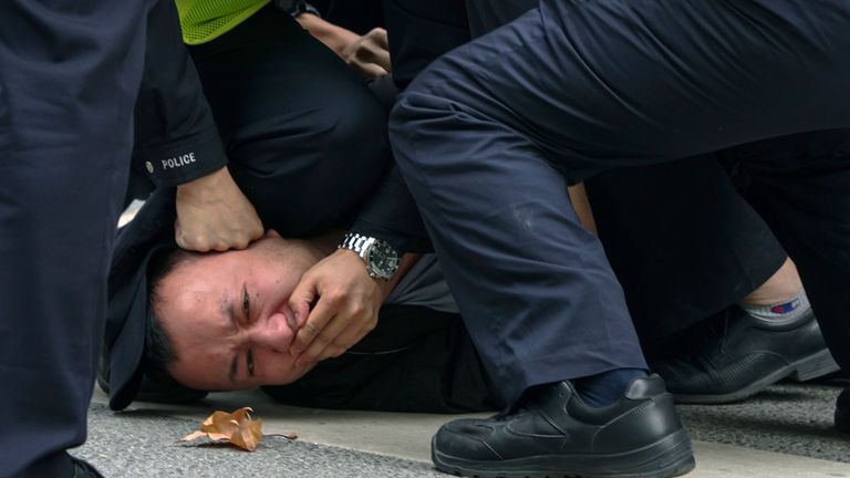 In this photo taken on Sunday, Nov. 27, 2022, policemen pin down and arrest a protester during a protest on a street in Shanghai, China
Pic:AP