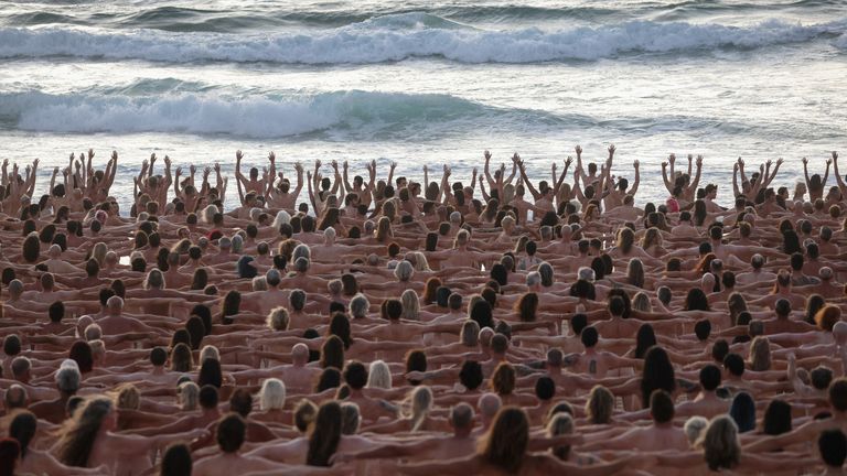 People stand naked as part of artist Spencer Tunick&#39;s art installation to raise awareness of skin cancer and encourage people to have their skin checked, at Bondi Beach in Sydney, Australia, November 26, 2022. REUTERS/Loren Elliott EDITORIAL USE ONLY.
