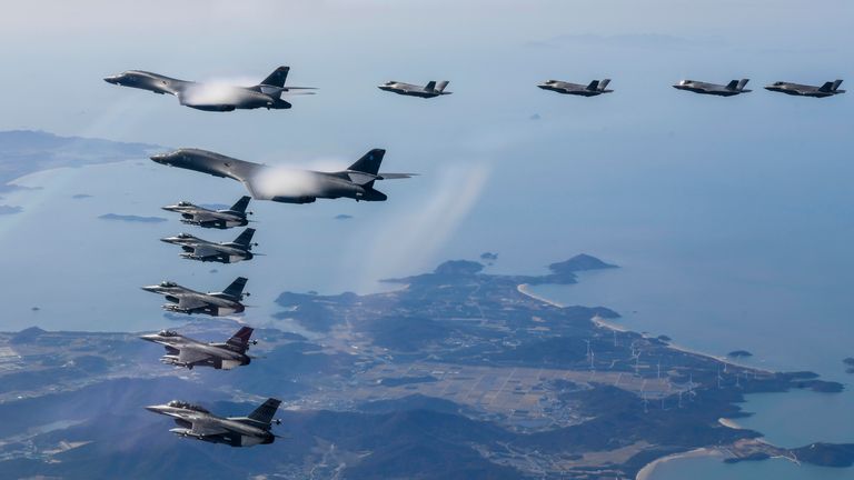 In this photo provided by South Korean Defense Ministry, two U.S. Air Force B-1B bombers, top center, South Korean Air Force F-35 fighter jets and US Air Force F-16 fighter jets, bottom left, fly over South Korea Peninsula during a joint air drill in South Korea, Saturday, Nov. 19, 2022. The United States responded to a North Korean missile launch by flying supersonic bombers in a show of force. (South Korean Defense Ministry via AP)