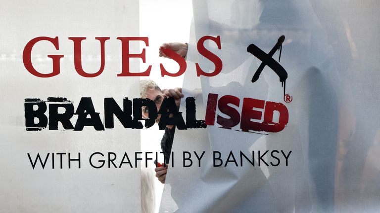 Following Banksy’s post, shop staff covered the inside of the window with large sheets of plain paper, obscuring the display