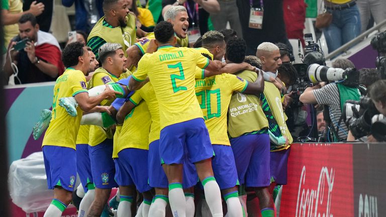 Brazil&#39;s Richarlison, right, is cheered by teamamtes after scoring during the World Cup group G soccer match between Brazil and Serbia, at the Lusail Stadium in Lusail, Qatar, Thursday, Nov. 24, 2022. (AP Photo/Aijaz Rahi)