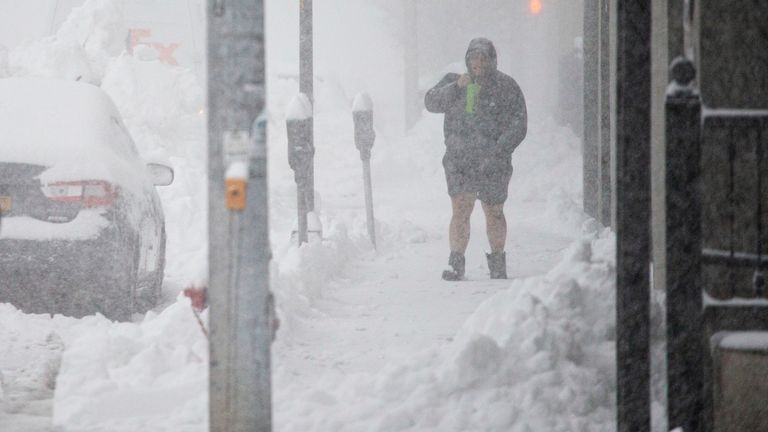 A person walks through downtown in the snow in Buffalo. Image: Associated Press 