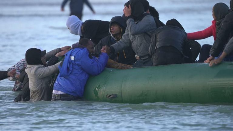 Migrants try to get on dinghies in Calais