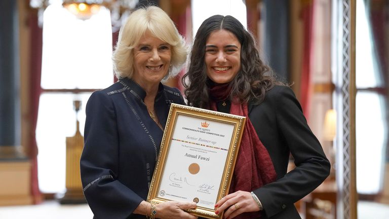 Britain&#39;s Camilla, the Queen Consort, with Amaal Fawzi at a reception for winners of the Queen&#39;s Commonwealth Essay Competition, at Buckingham Palace in London, Thursday Nov. 17, 2022. (Kirsty O&#39;Connor/Pool via AP)