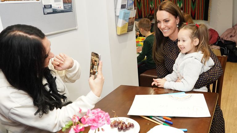 Kate poses for a happy selfie with one small girl