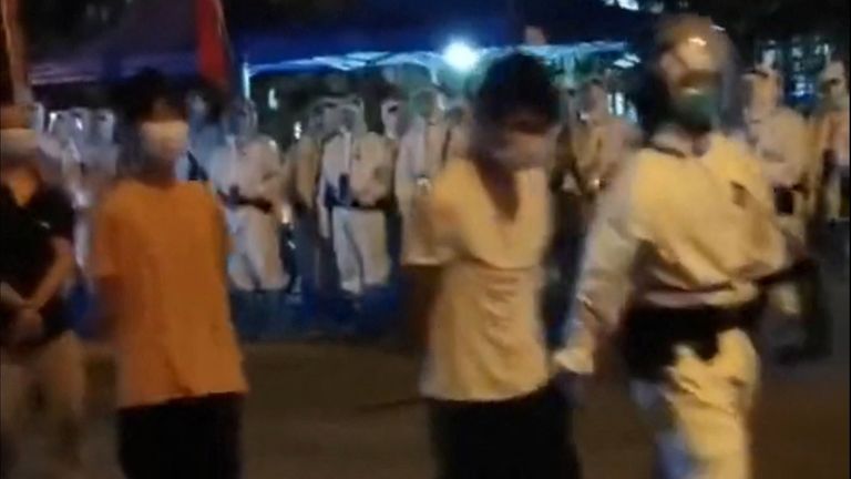 Footage posted on social media showed riot police officers in PPE escorting protesters during protests in Guangzhou, Guangdong province, China. Pic: via Reuters