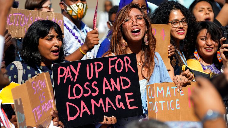 FILE - Mitzi Jonelle Tan, of the Philippines, center, participates in a Fridays for Future protest calling for money for climate action at the COP27 U.N. Climate Summit, Nov. 11, 2022, in Sharm el-Sheikh, Egypt.  As the U.N. climate talks in Egypt near the half-way point, negotiators are working hard to draft deals on a wide range of issues they...ll put to ministers next week in the hope of getting a substantial result by the end. (AP Photo/Peter Dejong, File)