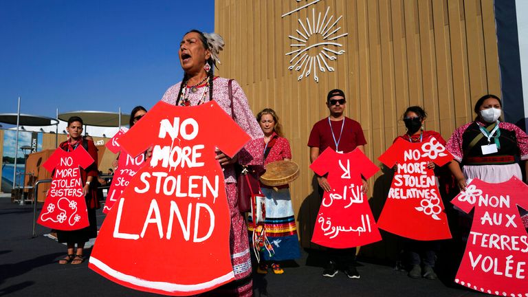 Demonstrators hold signs as part of a protest demanding no more stolen relatives and stolen land with the group Indigenous Women Action at the COP27 U.N. Climate Summit, Tuesday, Nov. 15, 2022, in Sharm el-Sheikh, Egypt. (AP Photo/Peter Dejong)