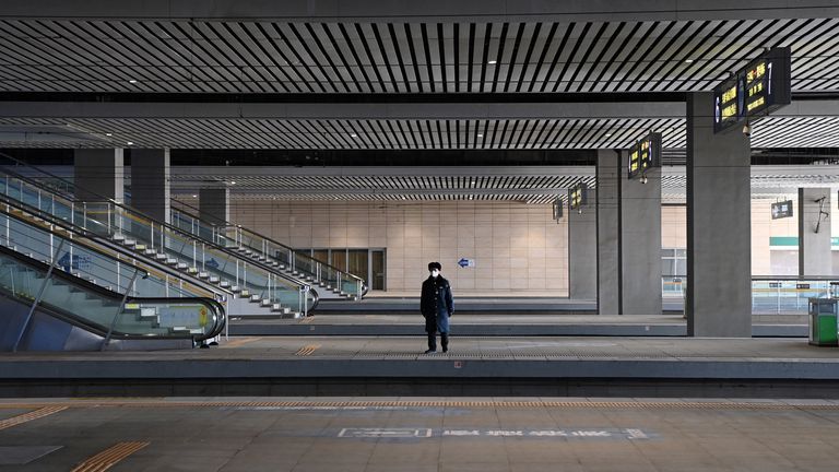 A staff member stands at an empty platform of Shijiazhuang Railway Station after passengers were banned from entering the railway station following a recent coronavirus disease (COVID-19) outbreak in Shijiazhuang, Hebei province, China January 9, 2021. cnsphoto via REUTERS ATTENTION EDITORS - THIS IMAGE WAS PROVIDED BY A THIRD PARTY. CHINA OUT.