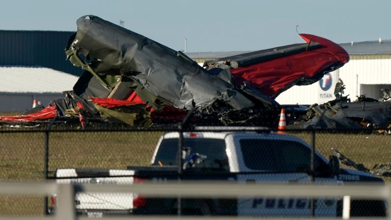 Debris from two planes that crashed during an airshow at Dallas Executive Airport lie on the ground, Nov. 12, 2022. Pic: AP