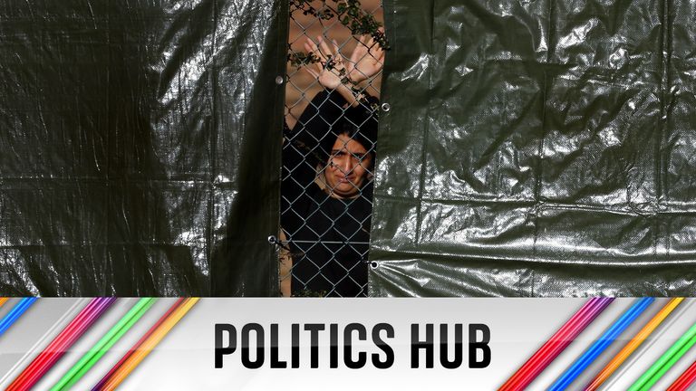A detainee gestures through a fence from inside an immigration processing centre in Manston, Britain, October 31, 2022. REUTERS/Hannah McKay    