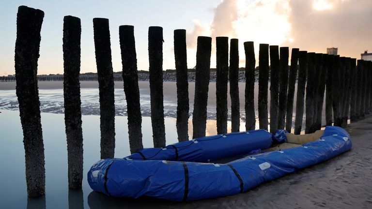  A damaged inflatable dinghy lies on the beach after a group of migrants traveled on it to leave the coast of northern France and to cross the English Channel, in Sangatte near Calais