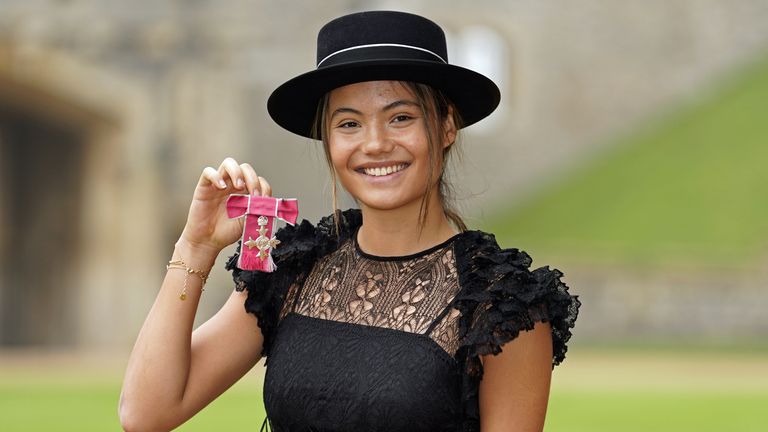 Raducanu beamed as she held up her MBE after King Charles presented it to her at Windsor Castle