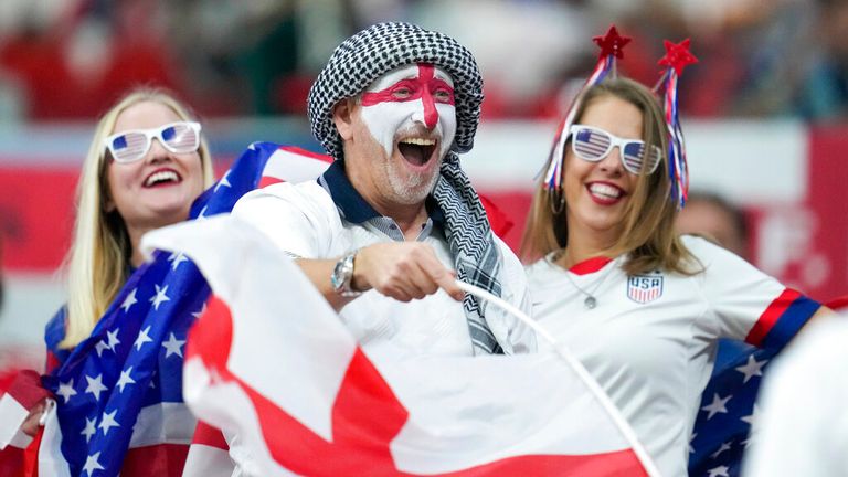 US and England supporters cheer their teams at the World Cup group B football game
