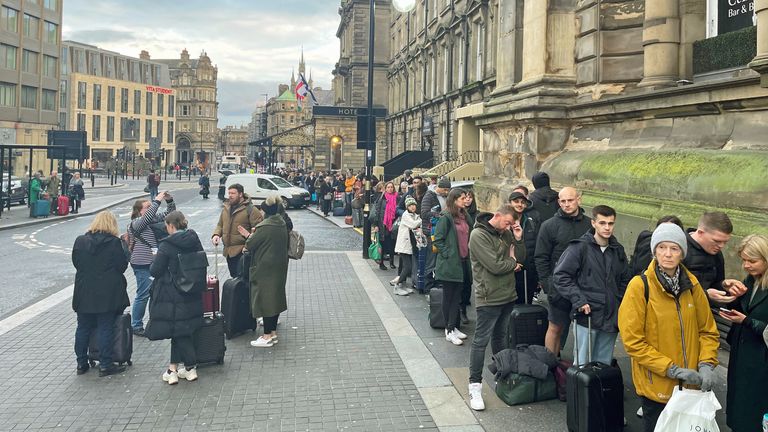 Hundreds of rail passengers queue outside Newcastle train station for replacement buses after trains to Scotland were cancelled due to flooding 