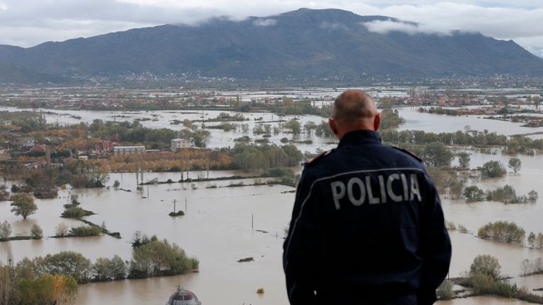 A policeman looks over a flooded area near Shkoder town, northwestern Albania, Monday, Nov. 21, 2022. Authorities say torrential rain over 48 hours in the Western Balkans have claimed at least six lives and flooded agricultural land and homes with Albania&#39;s districts of Shkoder and Lezhe being the most impacted areas. (AP Photo/Franc Zhurda)