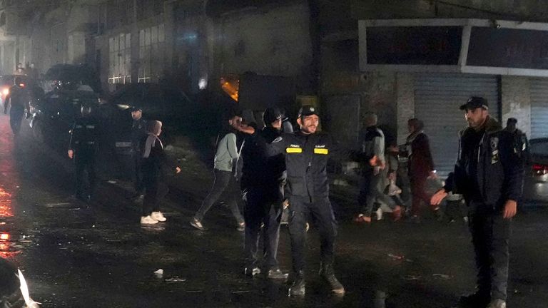 Hamas police officers secure the scene of burned apartment in Jabalia refugee camp. Pic: AP