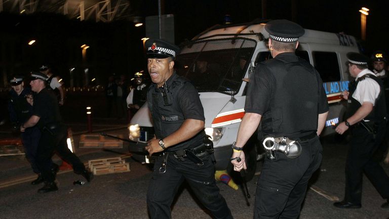 Police clear a barricade to allow a van, supposedly carrying Joel Glazer, to leave Old Trafford in 2005