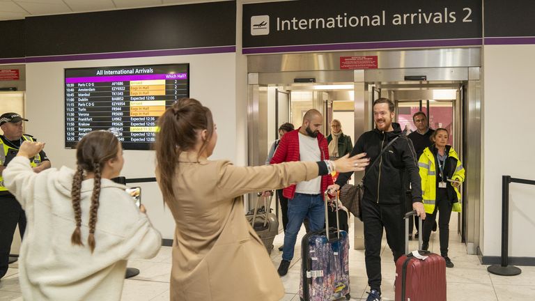 Scottish construction engineer Brian Glendinning with his wife and daughters after arriving at Edinburgh airport 