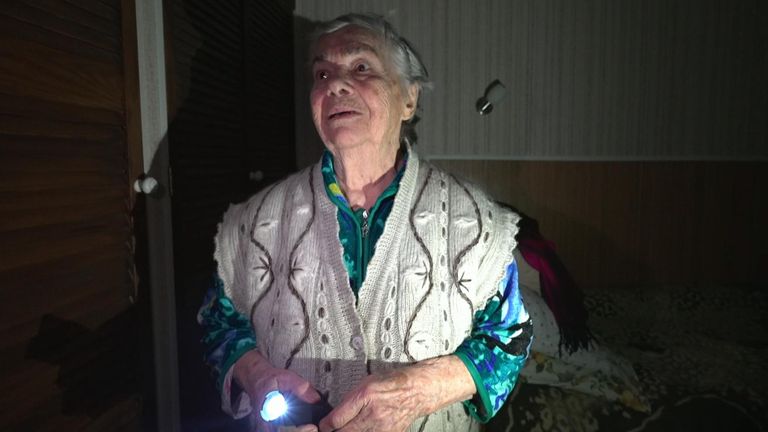 In the flicker of candlelight, a 91-year-old grandmother says she is scared as night falls, plunging her apartment block in Kyiv once more into darkness.
