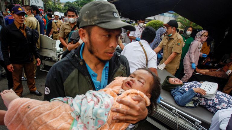 A man carries an injured child to receive treatment at a hospital, after an earthquake hit in Cianjur, West Java province, Indonesia
Pic:Antara Foto/Reuters