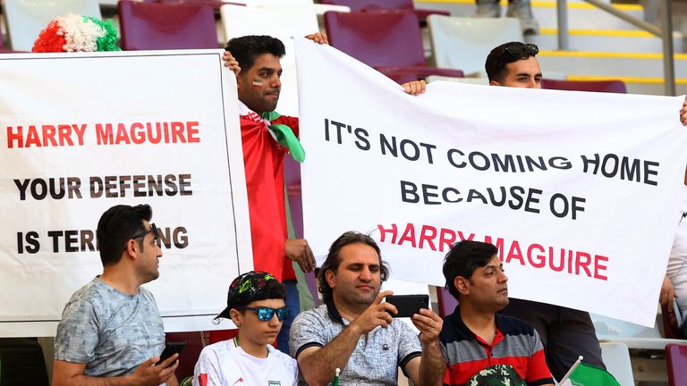  Iran fans display banners in reference to England&#39;s Harry Maguire inside the stadium before the match