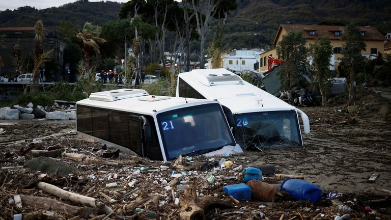 Damaged buses lie amongst debris following a landslide on the Italian holiday island of Ischia