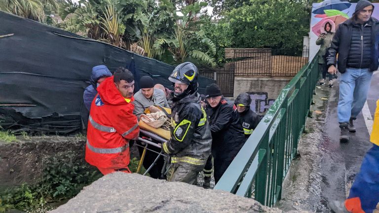 Rescuers carry someone on a stretcher