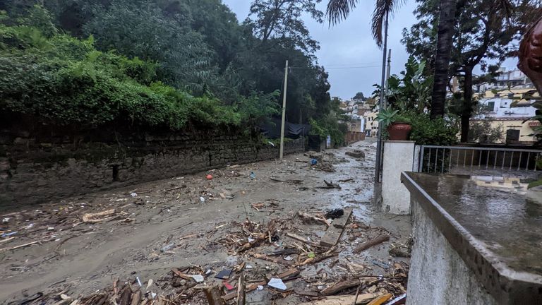 The remnants of buildings float down a street on the Italian holiday island