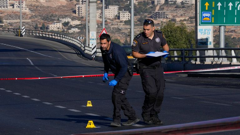 Israeli police inspect the scene of an explosion at a bus stop in Jerusalem, Wednesday, Nov. 23, 2022. Two blasts went off near bus stops in Jerusalem on Wednesday, injuring several people in what police said were suspected attacks by Palestinians. (AP Photo/Maya Alleruzzo)