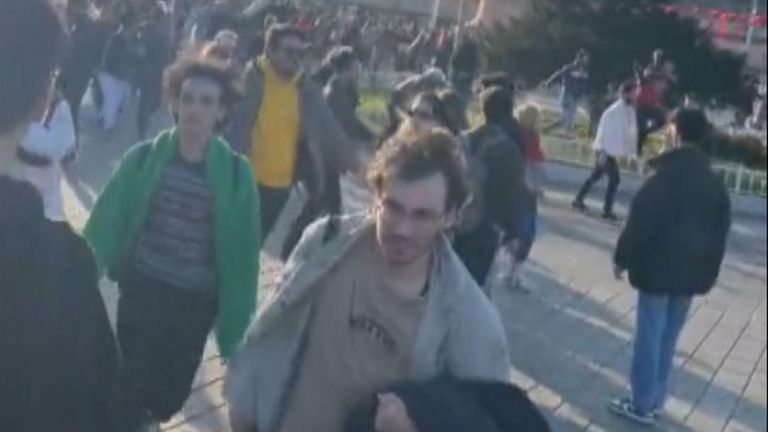 Pedestrians run after an explosion in Istanbul.