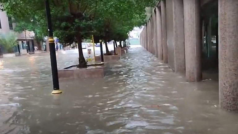 Footage posted online shows the inundated city streets, as well as people wading and cars driving slowly through floodwater.