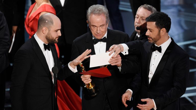 La La Land producer Jordan Horowitz, left, presenter Warren Beatty, centre, and host Jimmy Kimmel right, look at an envelope announcing Moonlight as best picture at the Oscars on Sunday, Feb. 26, 2017, at the Dolby Theatre in Los Angeles. Pic: Chris Pizzello/Invision/AP