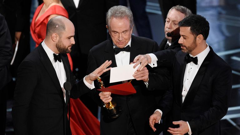 La La Land producer Jordan Horowitz, left, presenter Warren Beatty, center, and host Jimmy Kimmel right, look at an envelope announcing Moonlight for Best Picture at the Oscars on Sunday, February 26, 2017 at the Dolby Theater in Los Angeles.  Pic: Chris Pizzello / Invision / AP