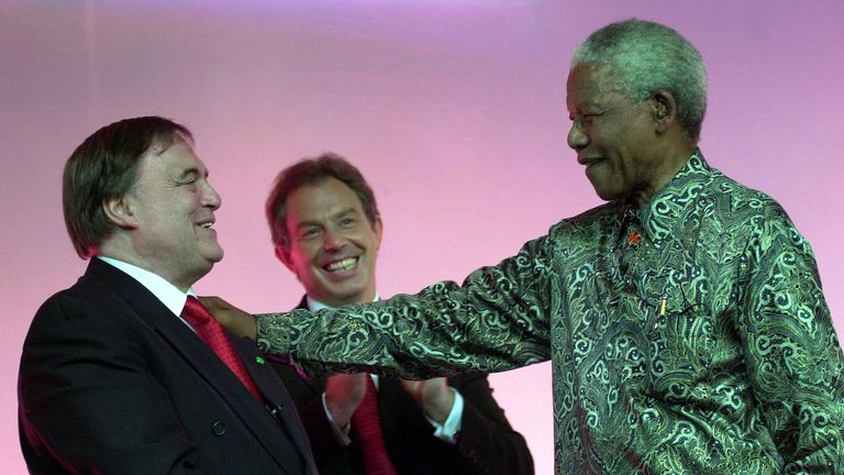 Former South African President Nelson Mandela is applauded by Prime Minister Tony Blair and John Prescott (left) at the Labor Party Conference in Brighton.