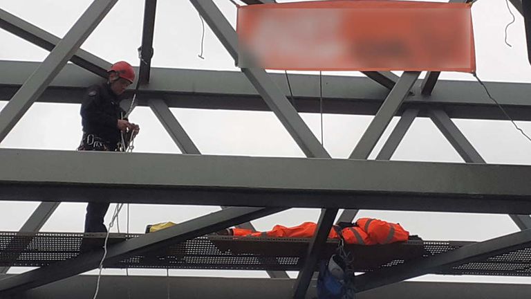 A Just Stop Oil protester on an overhead gantry at J30 of the M25. Pic: Essex Police