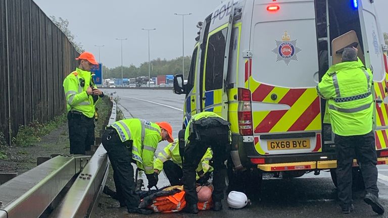 A protester is detained on the M25. Pic: Surrey Police