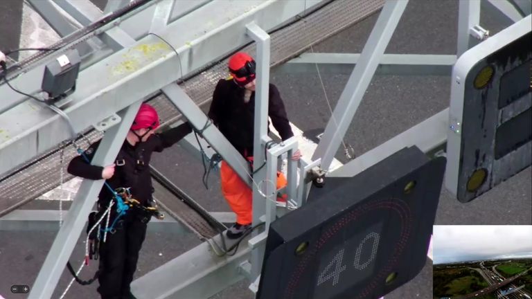 BEST QUALITY AVAILABLE Handout photo taken with permission from the twitter account @EssexPoliceUK of a specialist police officer, trained to work at heights working to remove a protestor from the gantry over junction 30 of the M25. Issue date: Wednesday November 9, 2022.