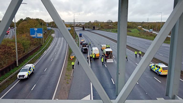 Handout photo issued by Just Stop Oil of the M25 closed by police due to ongoing protests from the group. Just Stop Oil said around 10 of its supporters climbed onto overhead gantries in "multiple locations" on the M25 from 6.30am on Wednesday, in what is the third consecutive day of protests on the UK&#39;s busiest motorway. Issue date: Wednesday November 9, 2022.